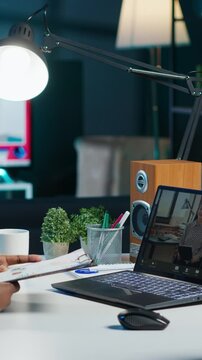 Vertical video Manager talking with collaborator working from home, holding teleconference meeting to present project. Team leader talking with employee showing charts on clipboard during online