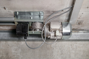 Parking gate engine or motor in parkade or garage of building. Close of sliding gate motor or...
