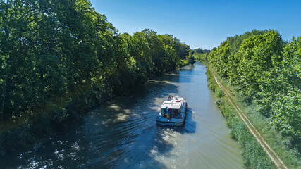 Vacation boat in Canal du Midi, family travel cruise by barge penichette, holidays in Southern France