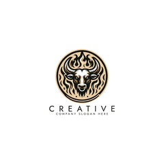 Obraz premium A bull head with horns in a circle with flames around it, Bull mascot vector design on a white background 