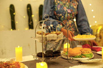 Woman Setting Table With Food For Graduation Party