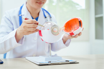 A male doctor wearing glasses sits at a desk in a hospital, explaining eye diseases like glaucoma, cataracts, pterygium, and diabetic retinopathy. Early detection helps prevent vision loss