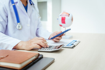 A male doctor wearing glasses sits at a desk in a hospital, explaining eye diseases like glaucoma,...