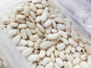 The white beans are in a bag in close-up. Legumes. Harvesting. 