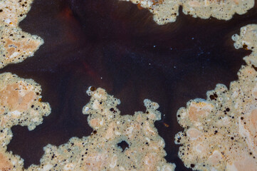 yellow abstract spots on black water.