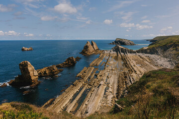Fototapeta premium Unique coastal rock formations jutting out into the ocean. Geological park