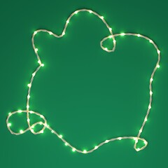Christmas greeting card template, banner mock up with copy space, space for text. Christmas festive lights garland on green background. Holiday background, beautiful fairy lights string party backdrop