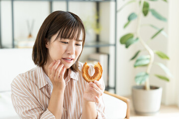 ドーナツを我慢する若い女性