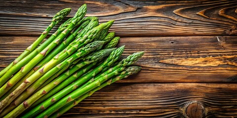 Fresh Asparagus Stalks on Rustic Wooden Table - Low Light Photography Capturing Nature's Green Beauty and Texture in a Cozy Kitchen Setting