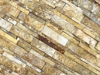 A wall made of brown bricks with a few gaps in between