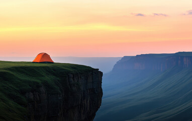Fototapeta premium vibrant orange tent pitched on cliff edge, overlooking stunning landscapes at sunset