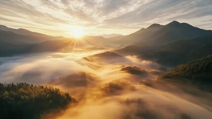 Obraz premium A breathtaking sunrise over misty mountains, revealing a serene landscape bathed in golden light and soft clouds.