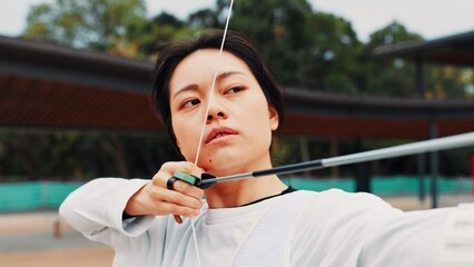 Woman, archery and aim at field with sport for shooting practice and training as athlete in Japan....