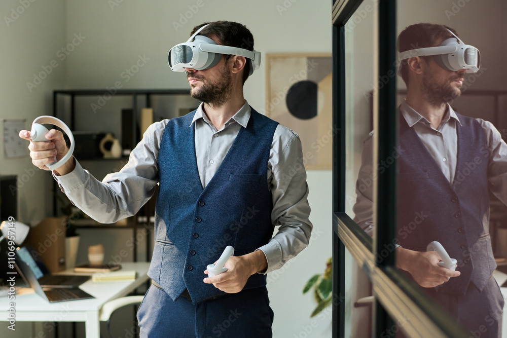 Poster Young male office worker in goggle using controllers during interactive presentation while standing in coworking space