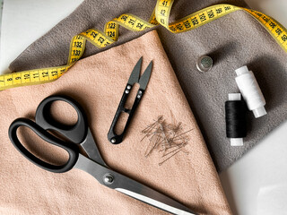 Sewing essentials. Tailoring tools with fabric, scissors, and measuring tape for creative projects