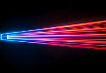 A vibrant light beam with multiple colors of red, blue, and purple against a black background.