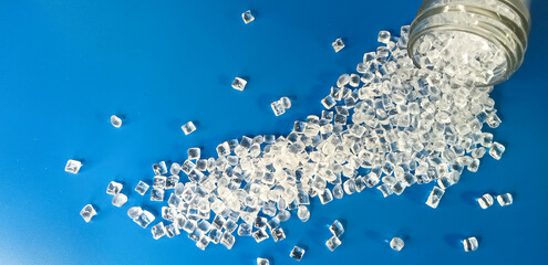 polymer plastic, virgin polymer resin granules type polycarbonate, isolated on blue background, for...