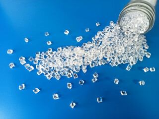polymer plastic, virgin polymer resin granules type polycarbonate, isolated on blue background, for...
