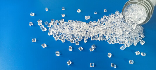 polymer plastic, virgin polymer resin granules type polycarbonate, isolated on blue background, for...