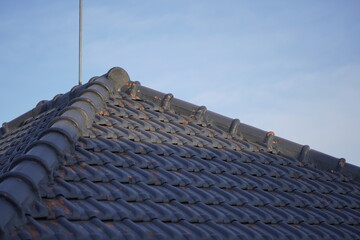 The blue triangular roof of the house in the afternoon