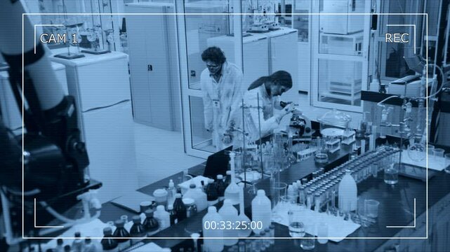 High-angle wide CCTV camera footage of male zombie scientist in filthy coat, with rotting flesh stumbling into chemical laboratory, joining female colleague abusing microscope, and thumping on laptop