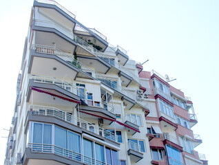 A tall building with balconies and a balcony railing