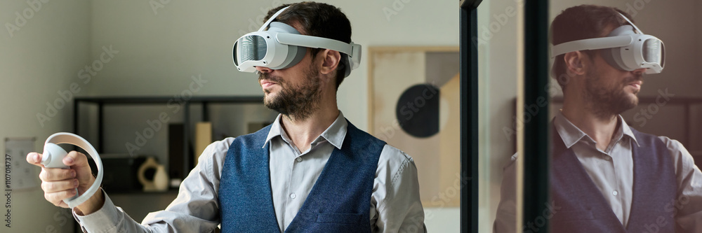 Poster Panoramic of young male office worker in goggle using controllers during interactive presentation while standing in coworking space