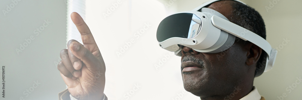 Poster banner of aged african american businessman with virtual reality headset pointing at augmented visua
