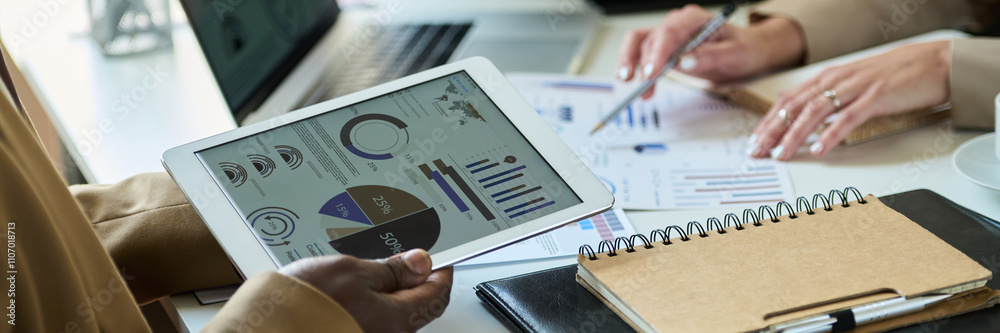 Poster header of hands of african american businessman holding tablet with graphic data on screen and prepa