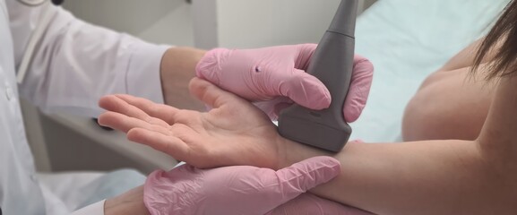 Doctor conducts ultrasound examination of patient child wrist
