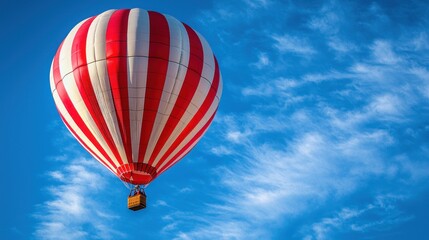 Fototapeta premium Red and White Striped Hot Air Balloon Ascending in a Blue Sky