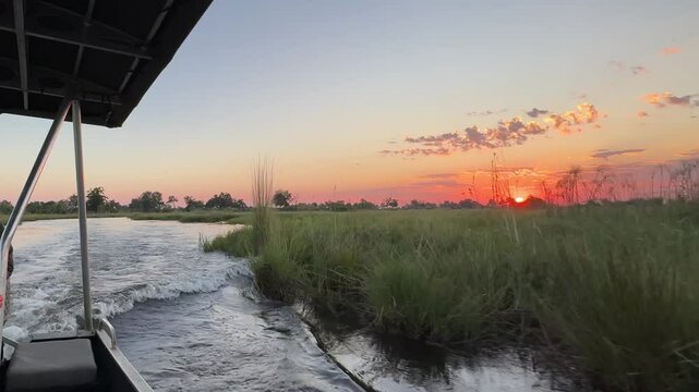 boat ride through Okovango delta botswana with sunset