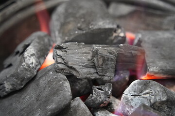 Burning charcoal in a brazier, closeup of photo