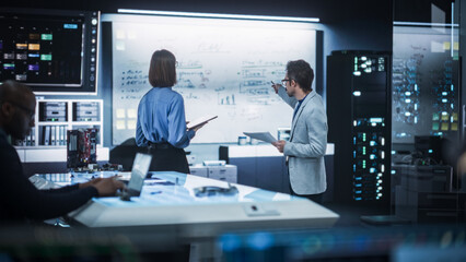 In Technological Research Facility: Portrait of a Team of Two Professional Engineers Using Digital...