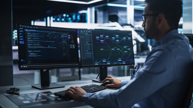 High-Tech Data Center Server Control: IT Specialist Administrator Working on Computer, Screen Showing Big Data AI Analysis and Code. Web Services, Machine Learning, Analytics Facility, Cyber Security