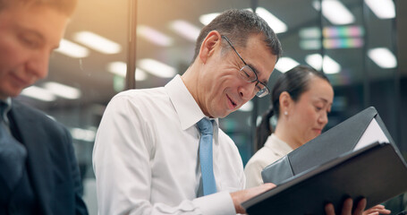 Happy man, waiting room and interview with documents in row for business resume, cv or application at office. Japan, male person or candidate with smile or paperwork for job or career opportunity