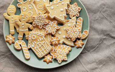 Christmas cookies with white icing forming various shapes lying on a plate