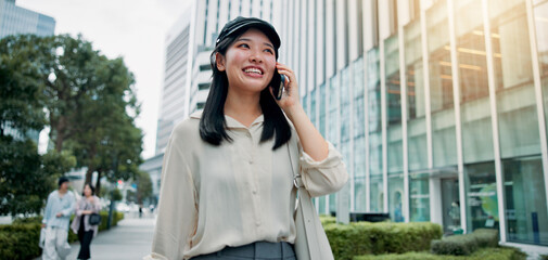 Fototapeta premium Woman, phone call and happy for travel in city with connection, outdoor or mobile network in street. Girl, smartphone and tourist with smile on urban sidewalk for commute, contact or chat in Japan
