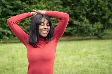 Joyful woman with raised arms expressing freedom and happiness outdoors