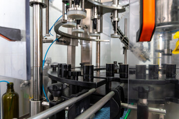 Industrial olive oil bottling machinery in modern production facility