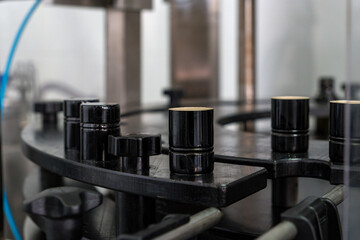 Close-up of bottle caps alignment system in olive oil production line