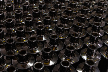 Obraz premium Dark glass bottles pattern in industrial oil production line, top view