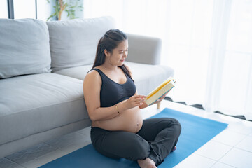 Pregnant asian woman reading book relaxation and Self-care during Pregnancy mother mindfulness...