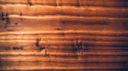 Full-frame view of Koa wood surface featuring smooth grain patterns and warm tones, ideal for woodworking, furniture design, natural backgrounds, and decorative materials. 