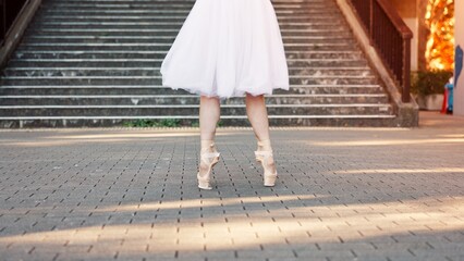 Woman, feet and ballet balance in city, outdoor and practice performance for art. Female person, professional dancer and creative talent in Japan, legs rehearsal and urban town for elegant training