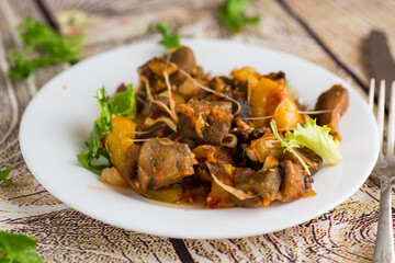 vegetable stew with eggplants, on a wooden table