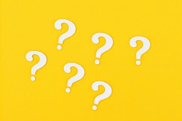 White question marks on a yellow background.