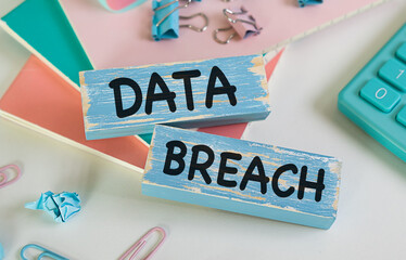 Wooden blocks with words Data Breach. Business concept
