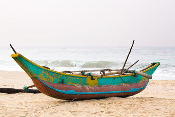 Fototapeta premium Colorful beautiful boat on the beach near the Ocean