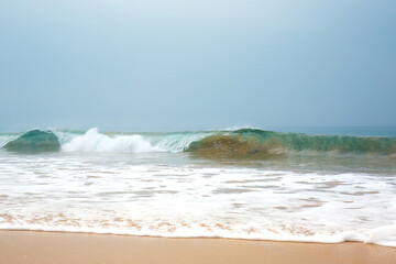 Blue waves with foam near the shore of the Indian Ocean